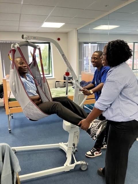 Spire Homecare staff practising moving and handling with a hoist during training
